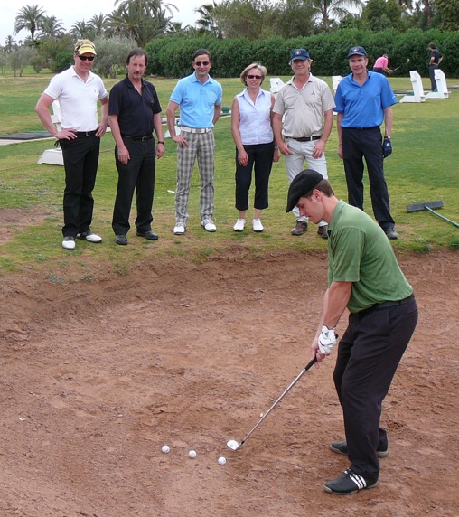 Jaacob Bowden demonstrates how to hit bunker shots to a group of students during a golf holiday in Marrakech, Morocco in 2011
