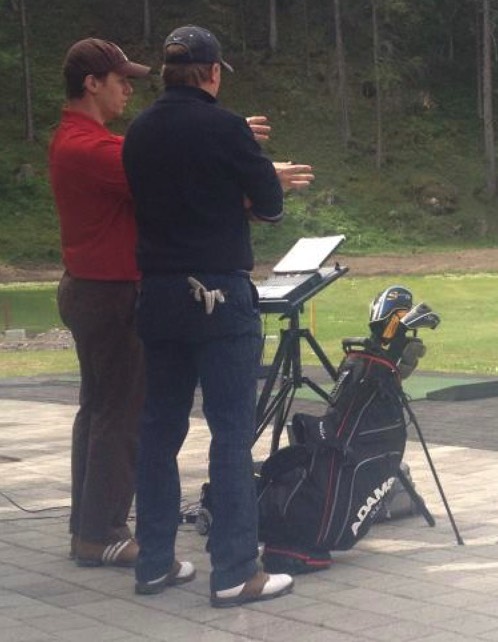 Jaacob Bowden works with a fellow pro on Trackman