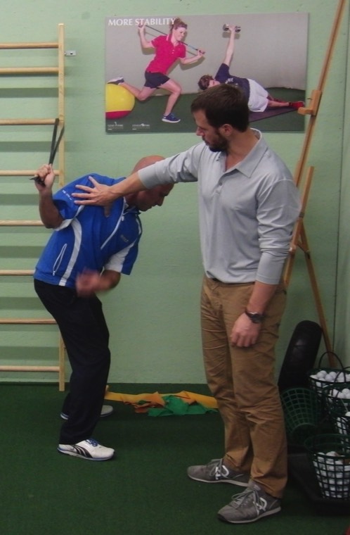 Jaacob Bowden helps a fellow golf professional during a swing speed training clinic for the Swiss PGA in 2013