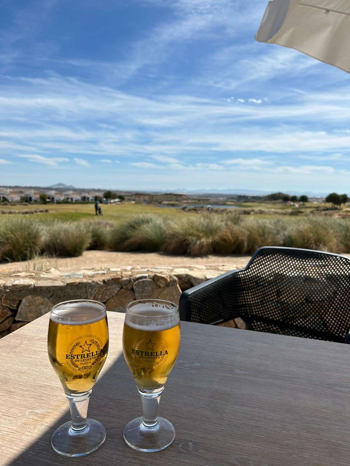Enjoying two beers on the patio overlooking El Valle Golf in Spain
