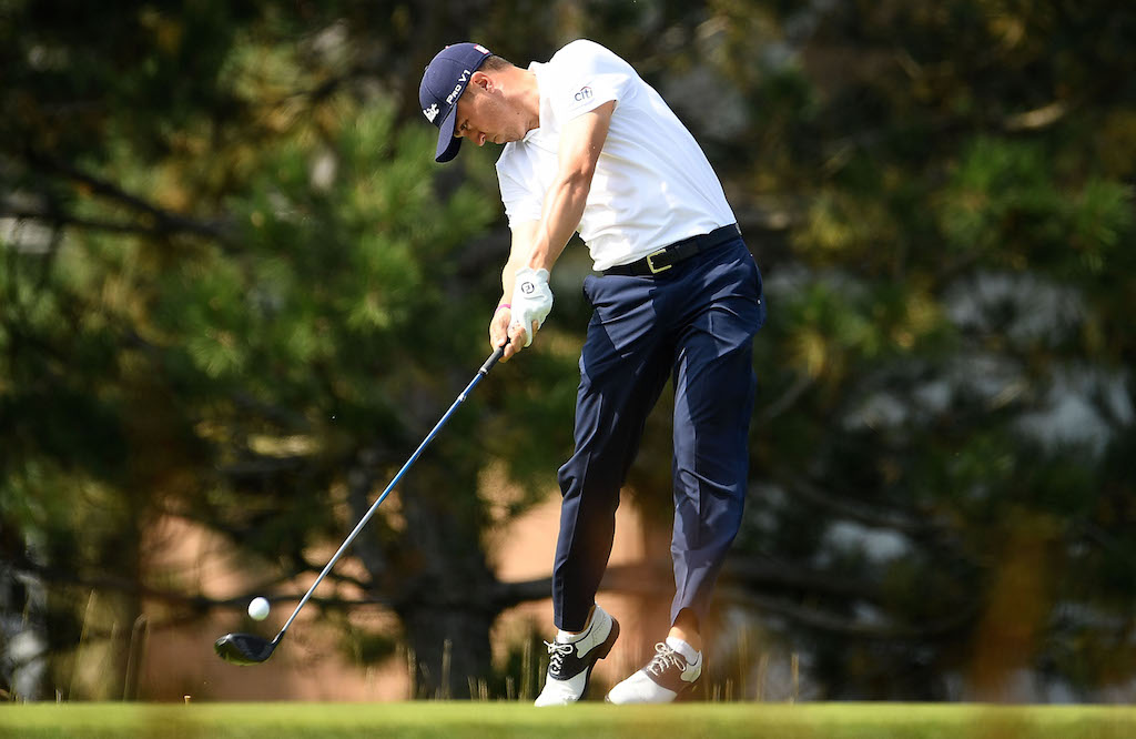 Justin Thomas jumps in to the air off two feet